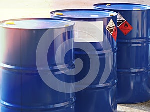 The close-up shot of blue color hazardous dangerous chemical barrels ,have warning labels of corrosive & flammable liquid