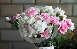 Close up shot of a bouquet of white and pink carnation flowers.