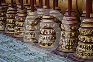 Close-up shot of buddhist prayer wheels in a row on a table