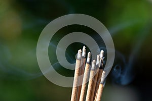 Close-up shot of burning incense with smoke. Asian beliefs