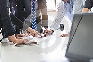 Close up shot business people team meeting in conference room in company. Businessman pointing pen at document on the table