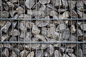 Close-up shot of a cade filled with small rocks photo