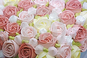 Close up shot of cake decorated with cream roses.