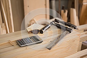 Close up shot of calculator and metal ruler , clam in carpenter workshop