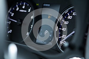 Close up shot of a car dashboard warning with the fuel icon lit.