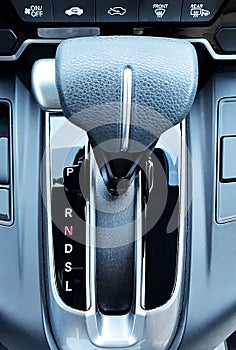 Close-up shot of a car gear shifter. Overhead view of automatic gear shift in park.
