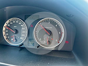 Close-up shot of a car's dashboard with the battery icon lit.