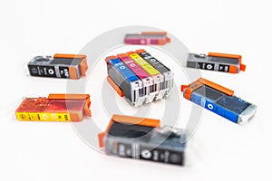 Close-up shot of a CMYK ink cartridges for a color printer isolated on a white background.