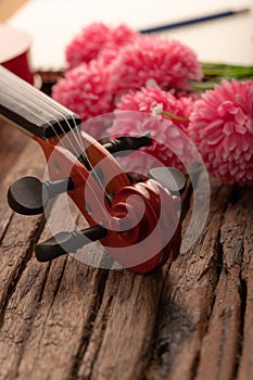 Close-up shot coffee cup and violin orchestra instrumental over wooden background select focus shallow depth of field