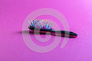 Close up shot of a colorful hairbrush. Concept