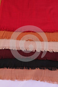 Close-up shot of colourful hijabs, fabrics, cloth or scarves. Textile industry or product photography