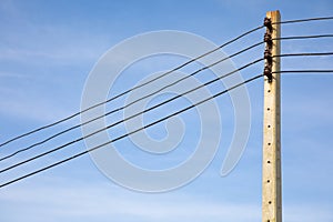 Close up shot with copy space of electricity pole and power cable lines installed in rural area shows the growth of industrial