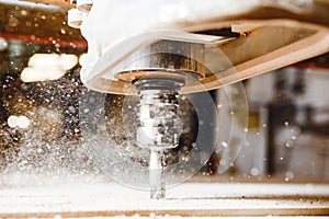 Close-up shot of cutting wood with a cnc milling machines.