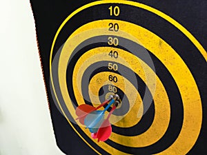 Close up shot of a dart board. Darts arrow Missing the target on a dart board during the game. Darts yellow