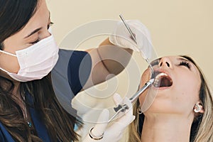 Close up shot of Dentist administering anesthesia to female patient