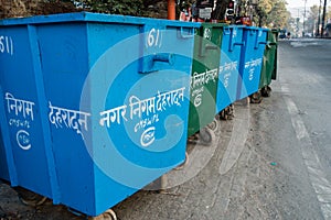 A close up shot of Dumpster i along side road in India. Written in hindi meaning municipal corporation , dehradun India