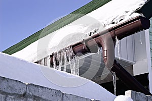 Close-up shot of a eavestrough at a standard roof. winter photo