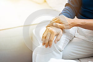 Close up shot of elderly senior couple holding hands and supporting with each other.