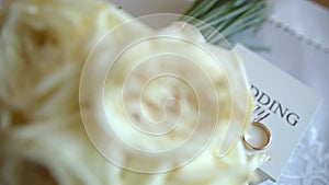 Close up shot of engagement wedding white roses of bridal bouquet lying on bed