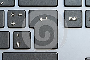 Close-up shot of an Enter key on a modern computer keyboard, completing an action, sending a chat message, applying for a job,