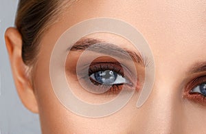 Close-up shot of female eye make-up in smoky eyes style