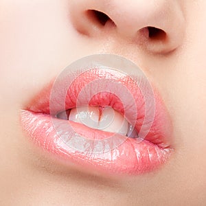 Close-up shot of female lips with healthy skin and rose color li