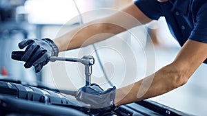 Close Up Shot of a Female Mechanic Working on a Vehicle in a Car Service. Empowering Woman Fixing