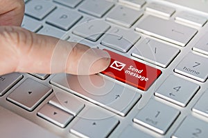 Close up shot of a finger clicking the SEND button on a laptop keyboard