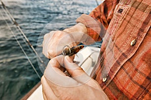 Close up shot of Fisherman Baiting Hook photo