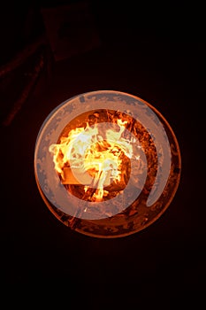 Close up shot of flames in the fire pit at night