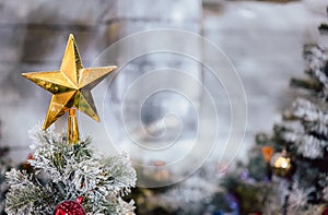 Close-up shot focus on yellow star from a decorated Christmas tree. Retro filter effect. Christmas tree and Christmas decorations