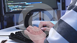 Close-up shot of IT freelancer's hand typing software code for application.