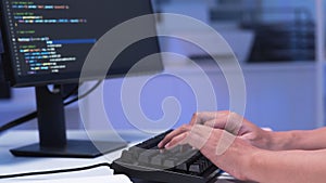 Close-up shot of IT freelancer's hand typing software code for application.