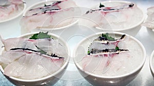 Close up shot of fresh fish fillets in bowls.