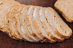 Close-up shot of a freshly sliced loaf of bread on a cutting board