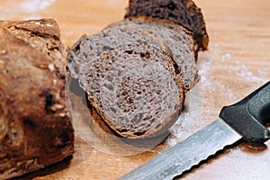 Close-up shot of a freshly sliced loaf of bread on a cutting board