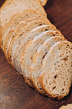 Close-up shot of a freshly sliced loaf of bread on a cutting board