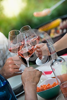 Close up Shot of Friends Tossing Glasses Rose Wine