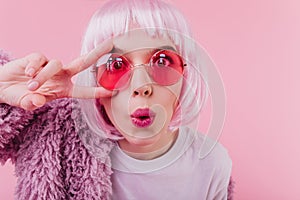 Close-up shot of funny surprised girl with bright makeup. Studio portrait of good-humoured lady in