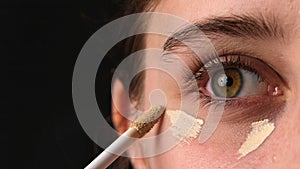 Girl Applying Concealer Under Eyes, Makeup Foundation For Eyelids Close Up Shoot photo