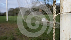 Close up shot of goal post as soccer ball fires into goal net. High quality