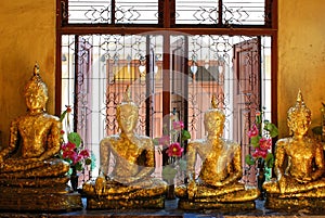 Close-up shot of Golden Buddha image in Thai Buddhist temple.