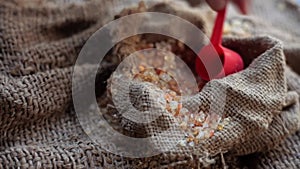 Close-up shot of gond, goond, edible gum, or gund katira crystals in a wicker basket on gunny bag surface.