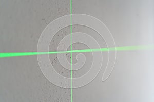 Green laser cross projection on textured wall