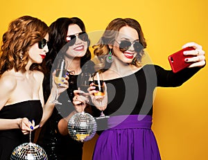 Close-up shot of group of laughing girls having party, take selfie with smartphone