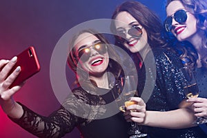 Close-up shot of group of laughing girls having party, take selfie with smartphone