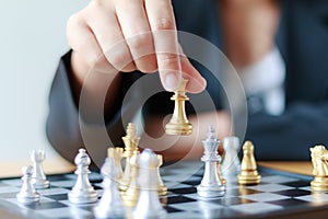 Close up shot hand of business woman moving golden chess to defeat a silver king chess on white and black chess board for