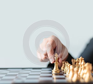 Close up shot hand of business woman moving golden chess to defeat a silver king chess on white and black chess board for