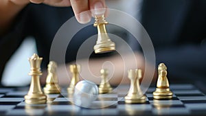 Close up shot hand of business woman moving golden chess to defeat a silver king chess on white and black chess board for business