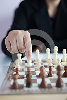 Close up shot hand of business woman playing the chess board to win by killing the king of opponent metaphor business competition